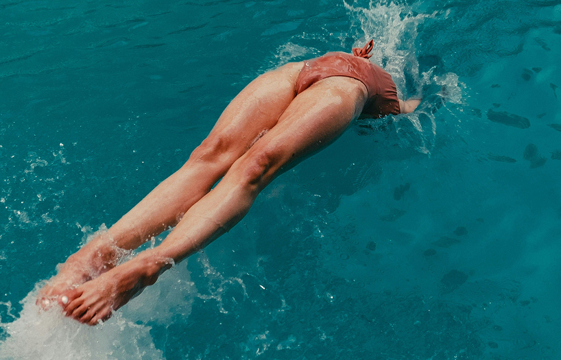 Active woman diving into a body of water, representing the energy and vitality benefits of adequate protein intake